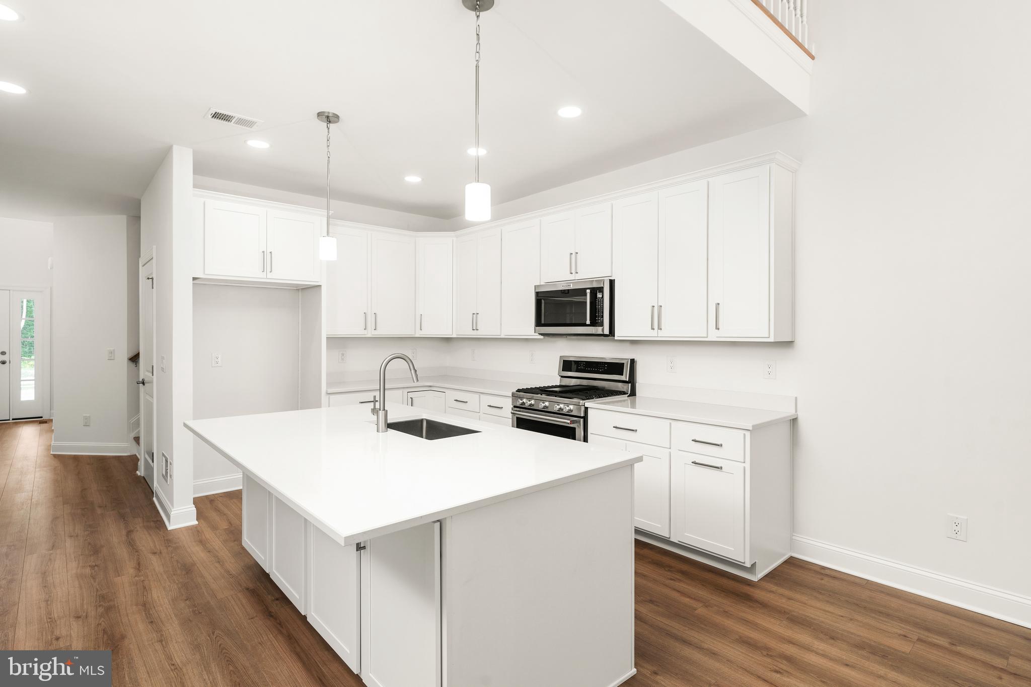 55 Kay Chiarello Way Hamilton, NJ 08690 - Photo 9 of 49 a kitchen with a sink a stove a refrigerator and white cabinets