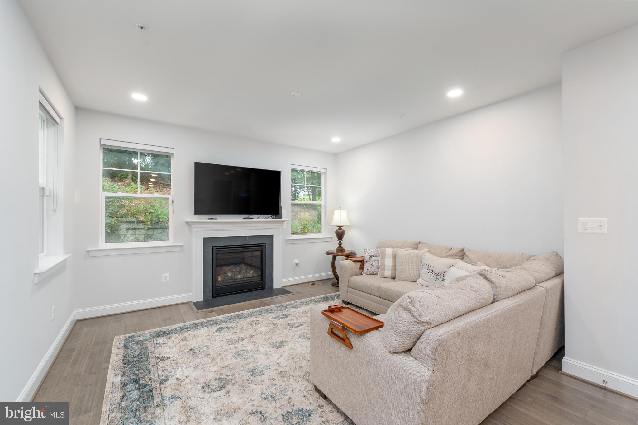 6210 Hunters Hollow Road Elkridge, MD 21075 - Photo 2 of 41 a living room with furniture a flat screen tv and a fireplace