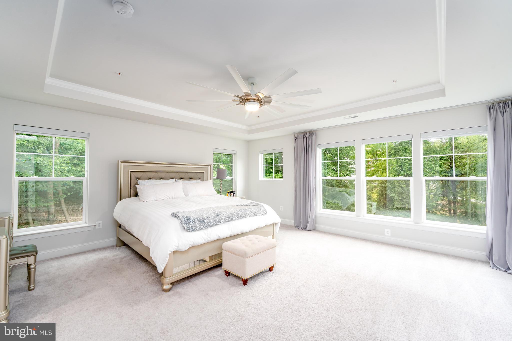 6210 Hunters Hollow Road Elkridge, MD 21075 - Photo 21 of 41 a spacious bedroom with a large bed and a large window