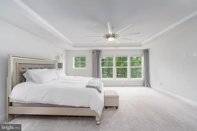 a large bed sitting in a bedroom next to a window