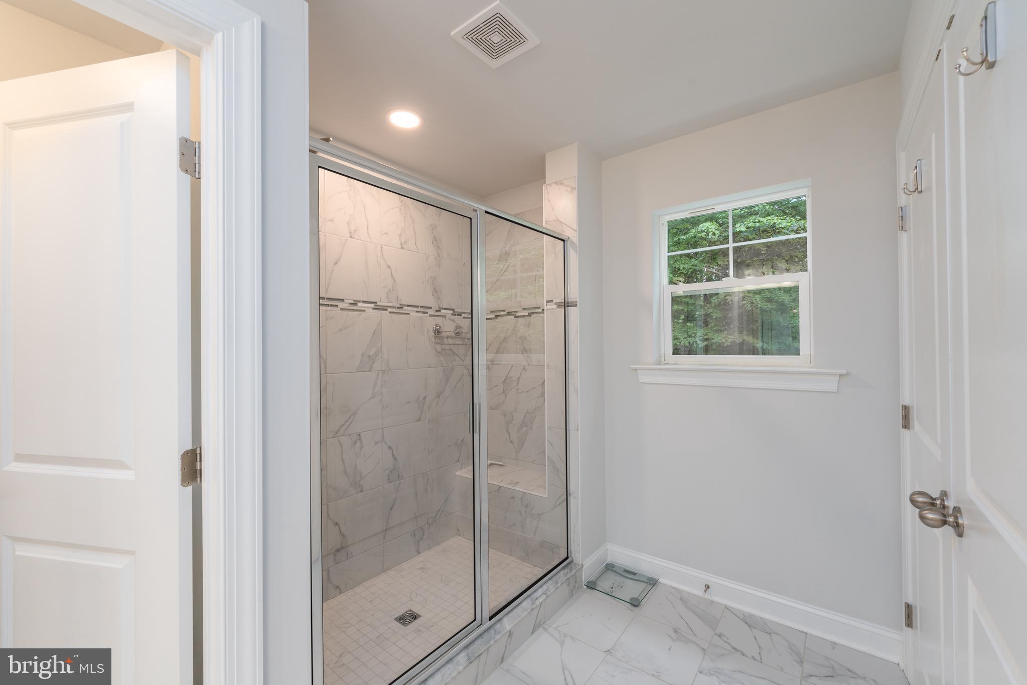 6210 Hunters Hollow Road Elkridge, MD 21075 - Photo 24 of 41 a bathroom with a glass shower door