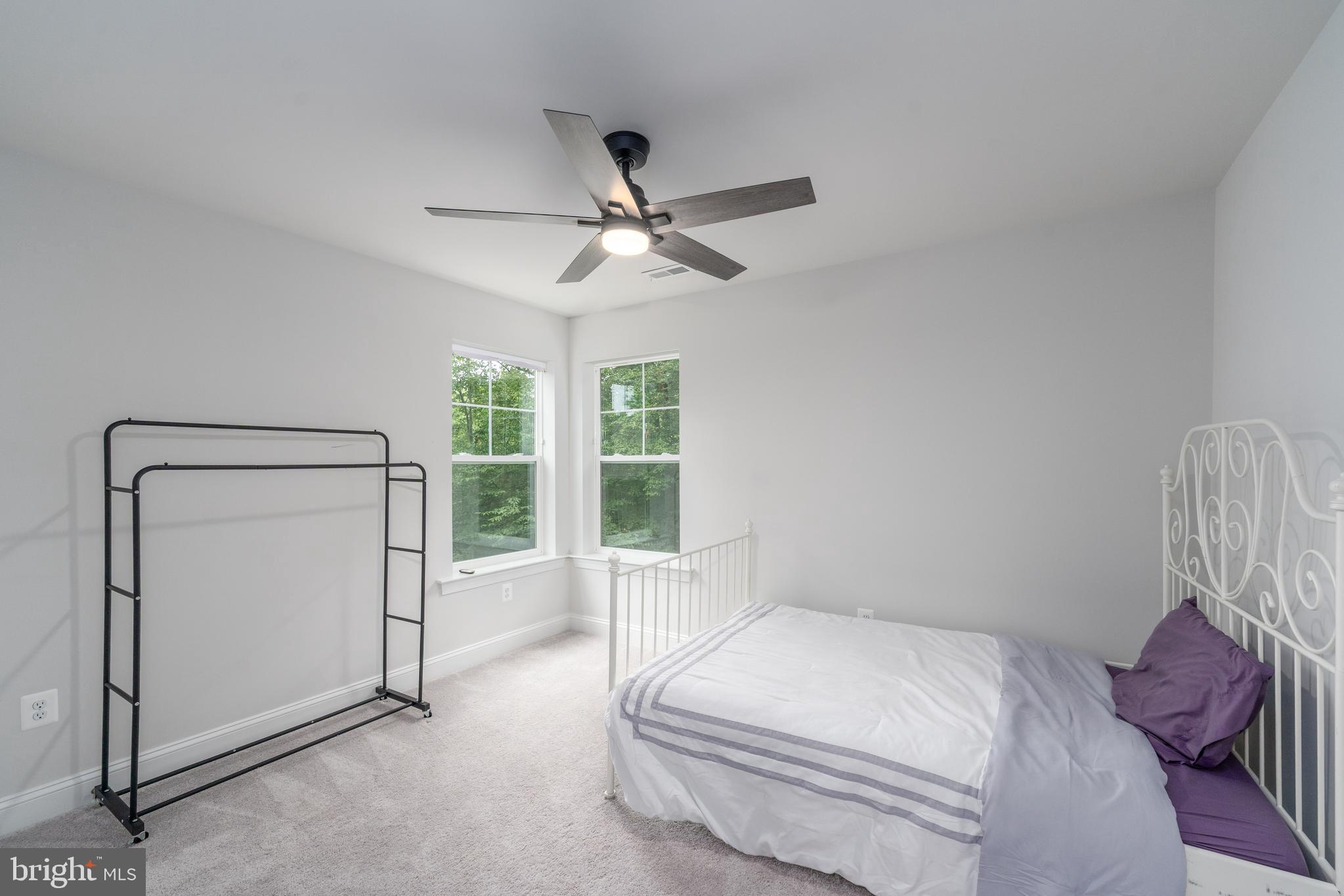 6210 Hunters Hollow Road Elkridge, MD 21075 - Photo 25 of 41 a bedroom with a large bed and a ceiling fan