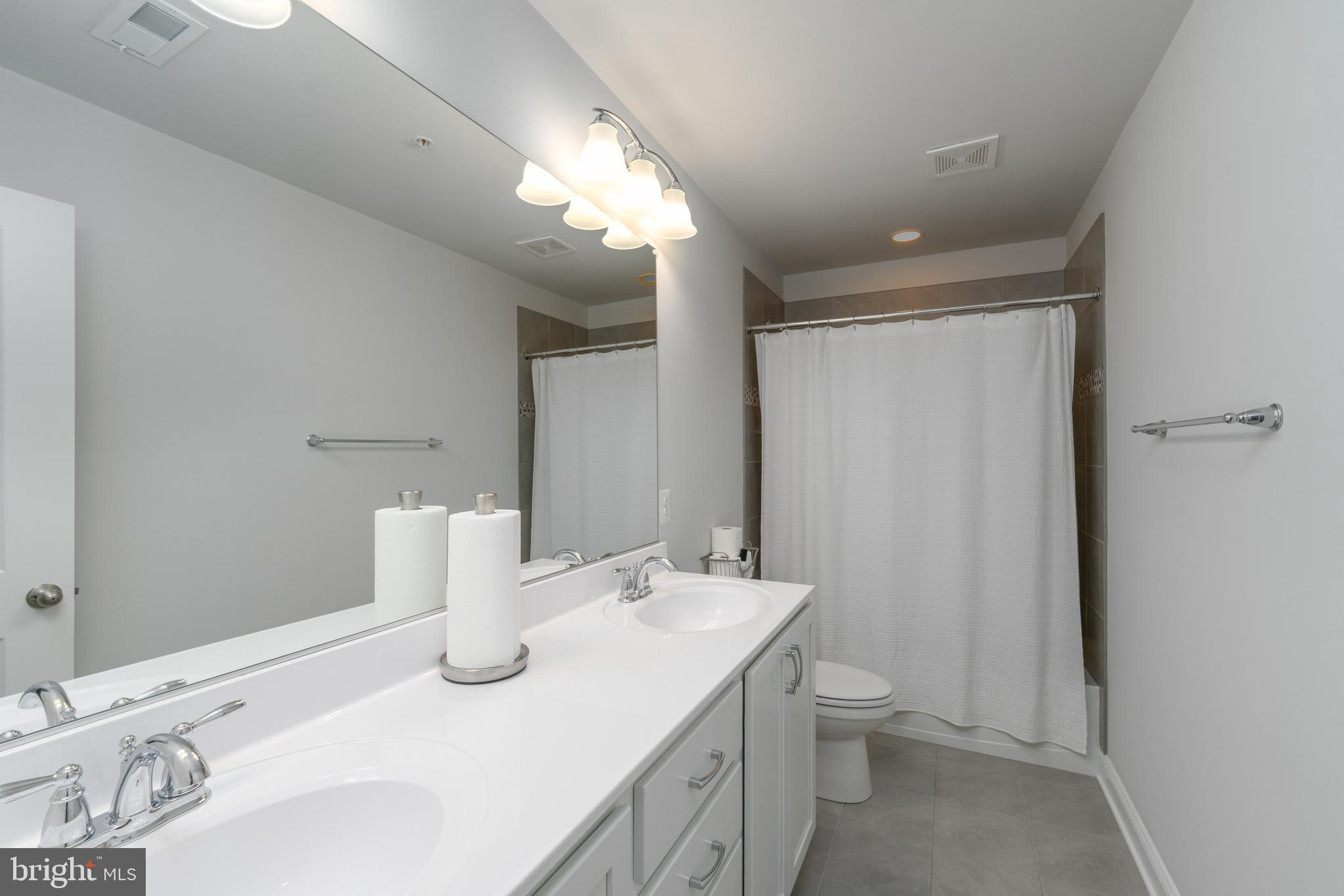 6210 Hunters Hollow Road Elkridge, MD 21075 - Photo 27 of 41 a bathroom with a sink and a mirror