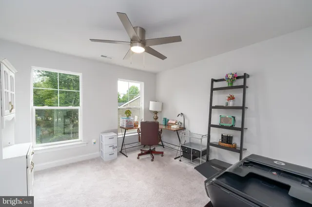 a living room with furniture a window and a flat screen tv