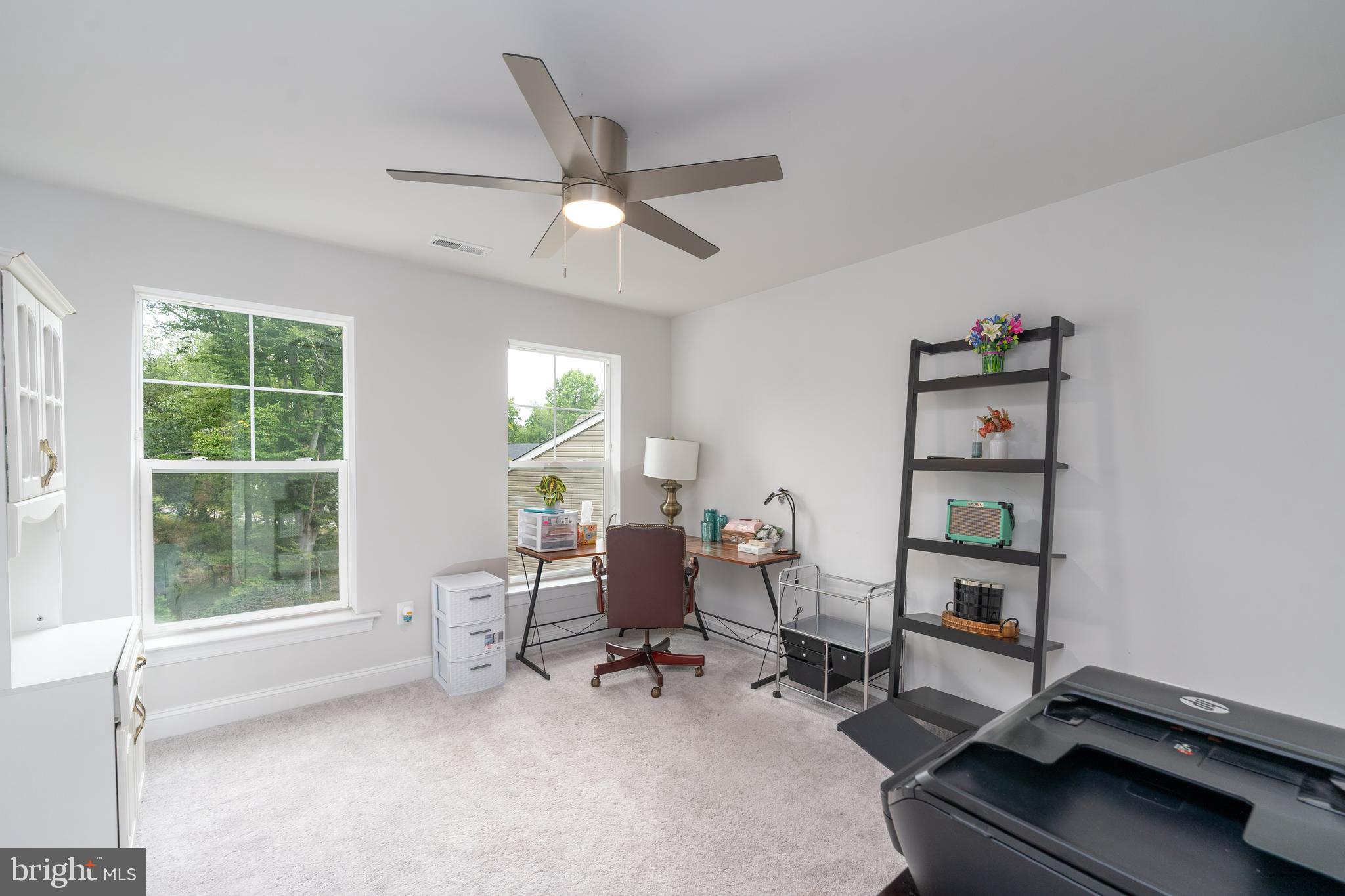 6210 Hunters Hollow Road Elkridge, MD 21075 - Photo 28 of 41 a living room with furniture a window and a flat screen tv