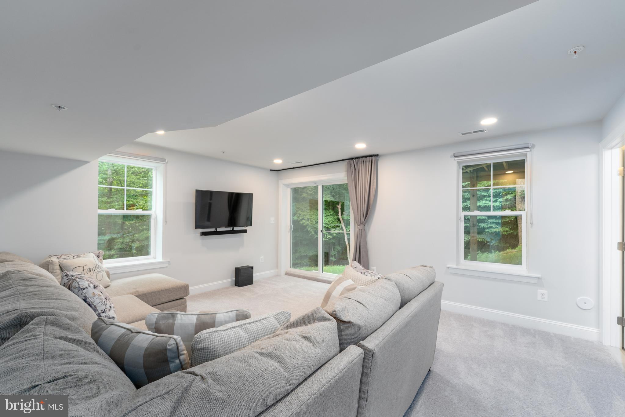 6210 Hunters Hollow Road Elkridge, MD 21075 - Photo 30 of 41 a living room with furniture window and a flat screen tv