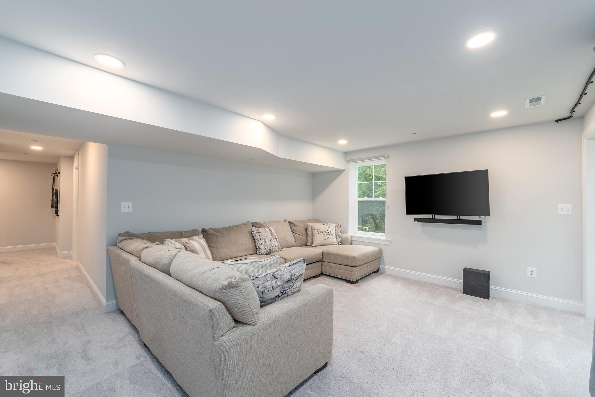 6210 Hunters Hollow Road Elkridge, MD 21075 - Photo 31 of 41 a living room with furniture and a flat screen tv