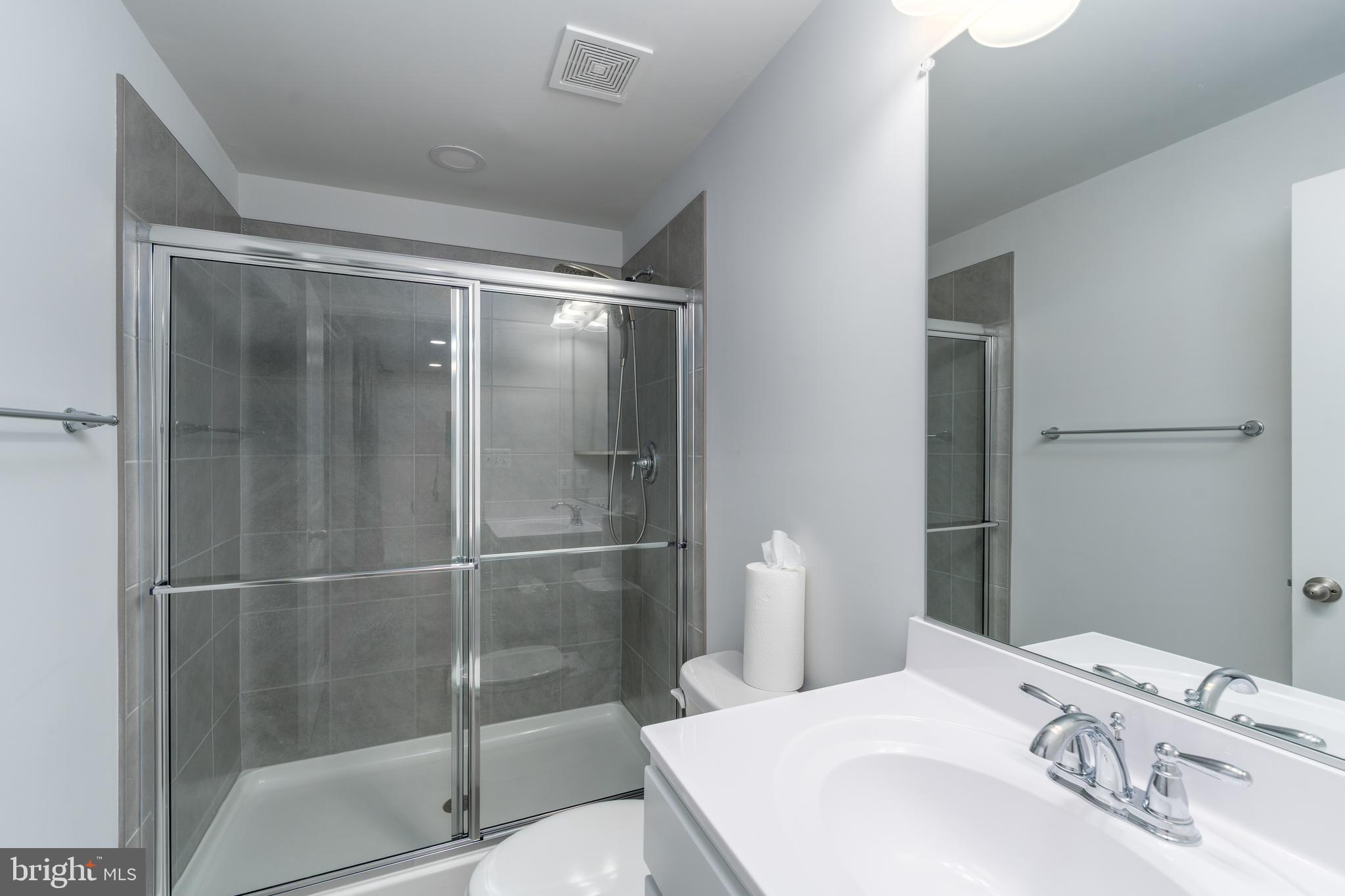 6210 Hunters Hollow Road Elkridge, MD 21075 - Photo 33 of 41 a bathroom with a sink and a mirror