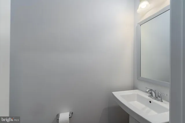 a bathroom with a sink and mirror