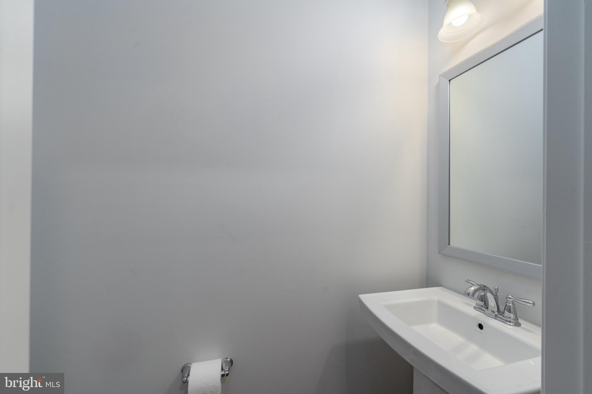 6210 Hunters Hollow Road Elkridge, MD 21075 - Photo 36 of 41 a bathroom with a sink and mirror