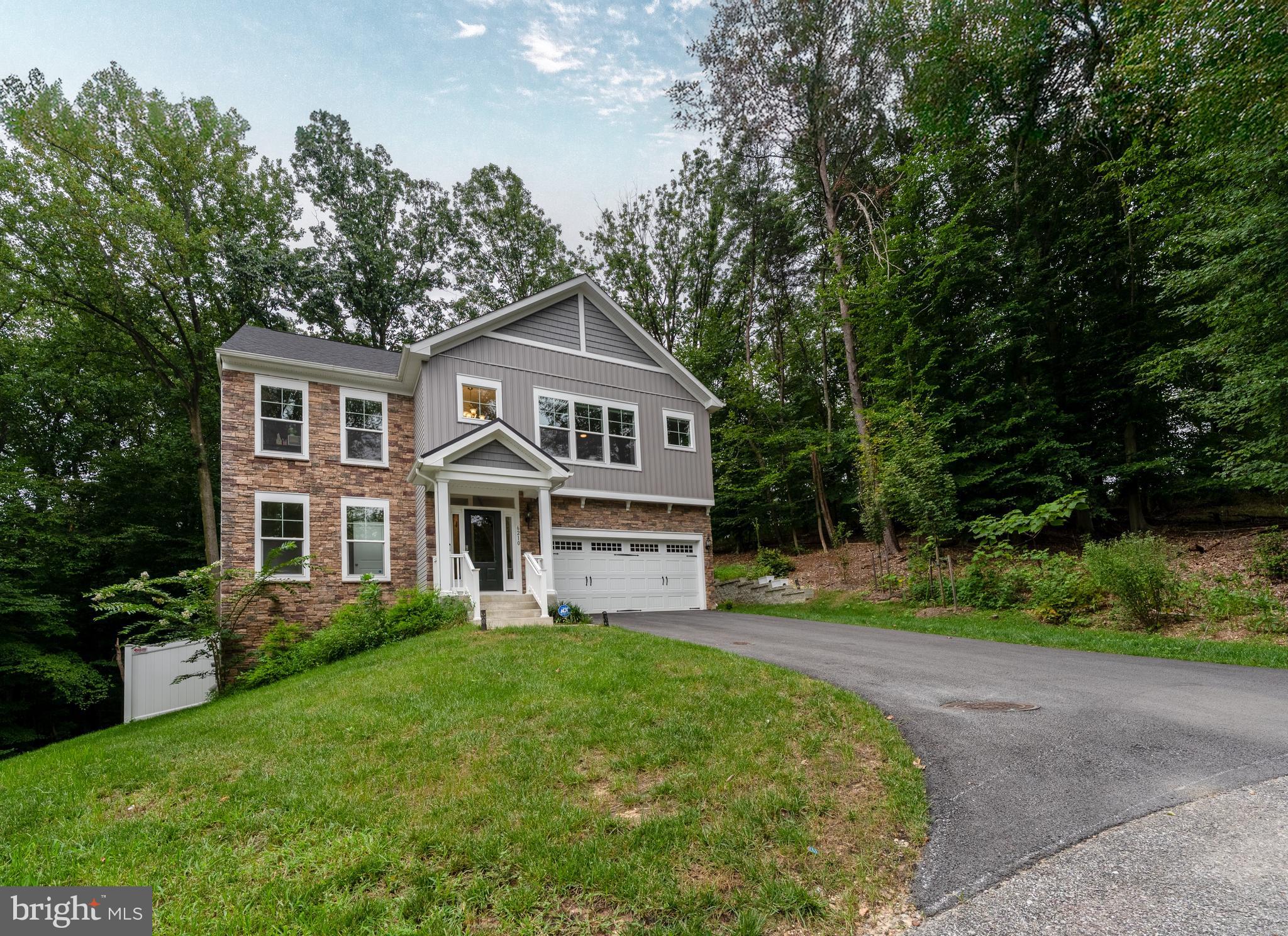 6210 Hunters Hollow Road Elkridge, MD 21075 - Photo 38 of 41 a front view of a house with a yard and trees