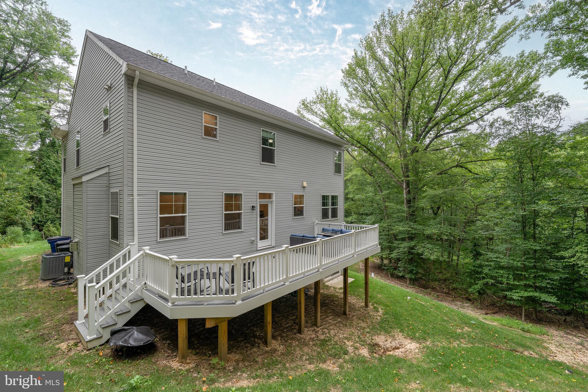 6210 Hunters Hollow Road Elkridge, MD 21075 - Photo 39 of 41 a view of a house with a wooden deck and a yard