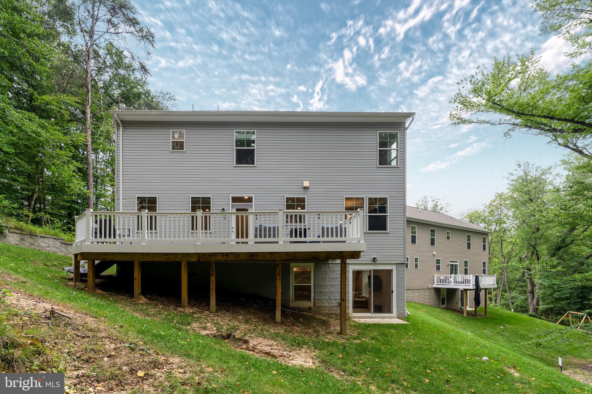 6210 Hunters Hollow Road Elkridge, MD 21075 - Photo 40 of 41 a backyard of a house with table and chairs