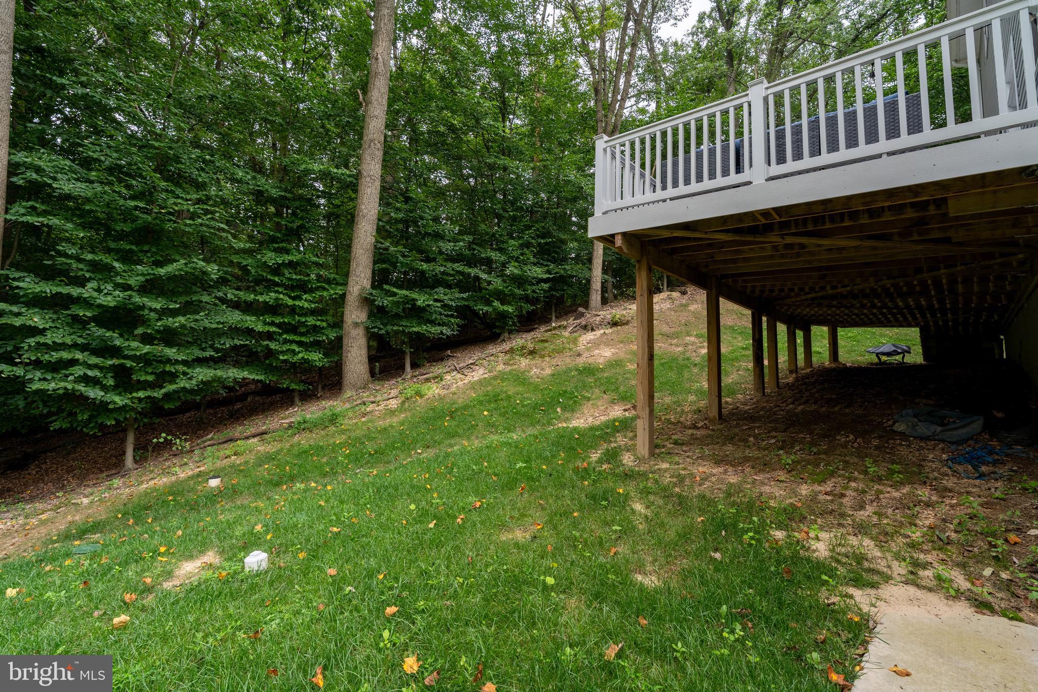 6210 Hunters Hollow Road Elkridge, MD 21075 - Photo 41 of 41 a view of a wooden deck and backyard with a small cabin