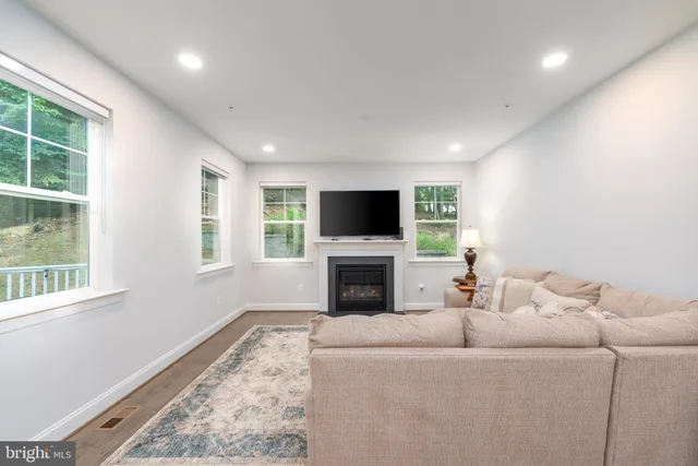 a living room with a flat screen tv and a fireplace