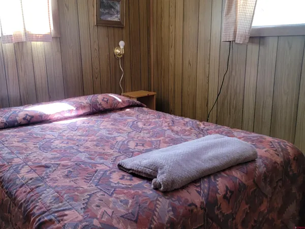 a bedroom with a bed and curtain