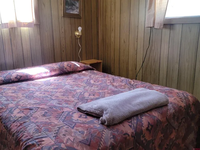 a bedroom with a bed and curtain