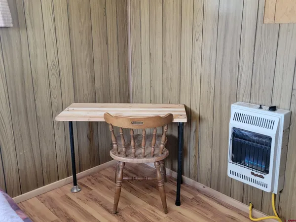 a view of a room with furniture wooden floor and fan