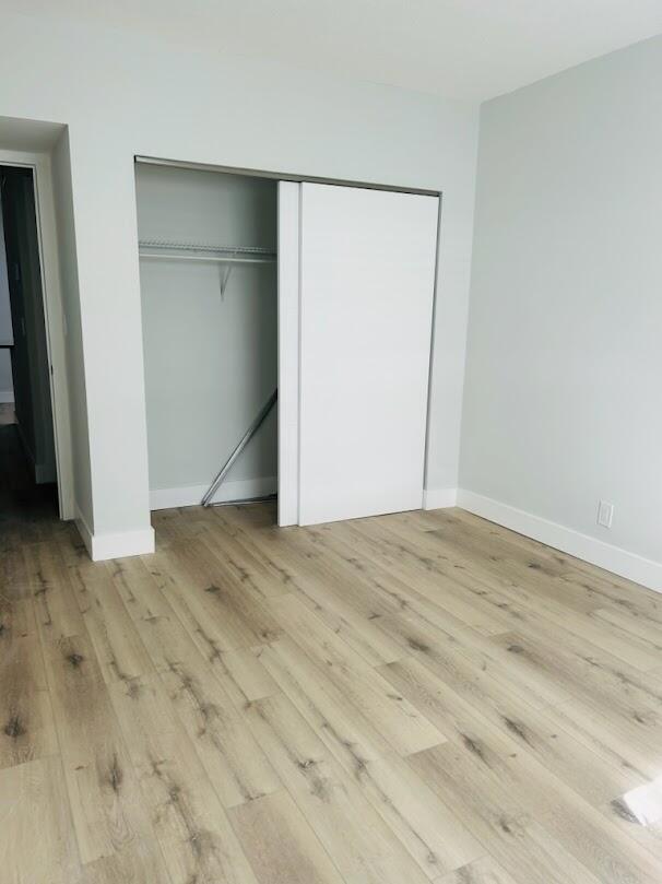 260 Northwest 19th Street, Unit 6 Boca Raton, FL 33432 - Photo 7 of 11 an empty room with wooden floor and closet