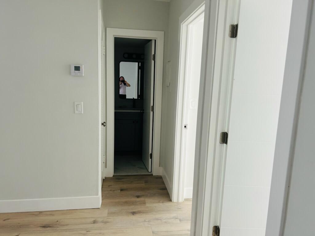 260 Northwest 19th Street, Unit 6 Boca Raton, FL 33432 - Photo 9 of 11 a view of a hallway with wooden floor and closet