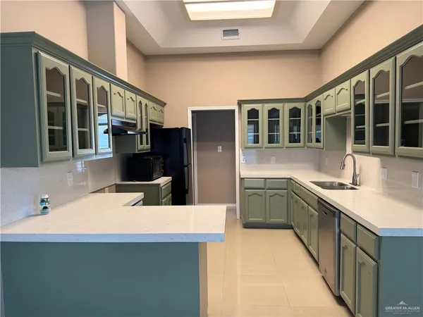 a kitchen with stainless steel appliances a sink and a refrigerator