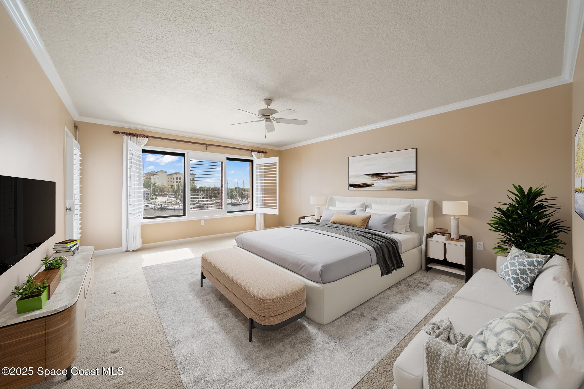 2220 Front Street, Unit 303 Melbourne, FL 32901 - Photo 26 of 27 a spacious bedroom with a large bed and a flat tv screen on dresser