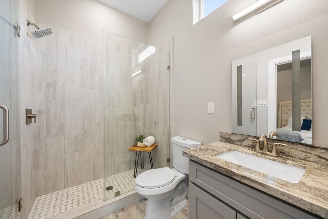 317 East 35th Street, Unit A Houston, TX 77018 - Photo 16 of 24 a bathroom with a granite countertop sink toilet and shower