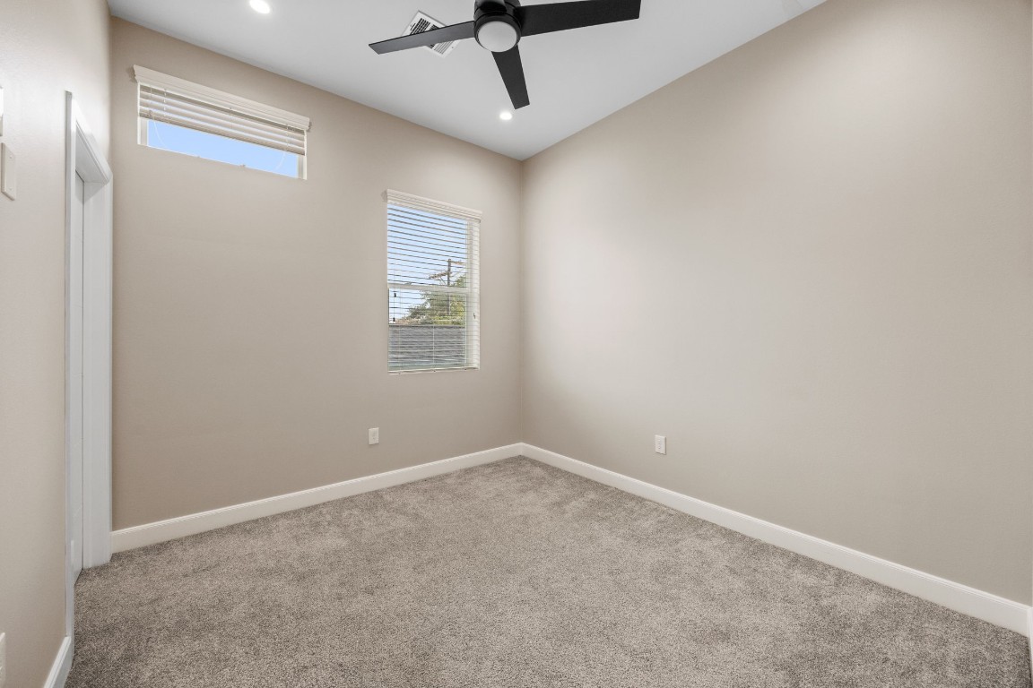 317 East 35th Street, Unit A Houston, TX 77018 - Photo 19 of 24 an empty room with windows and ceiling fan