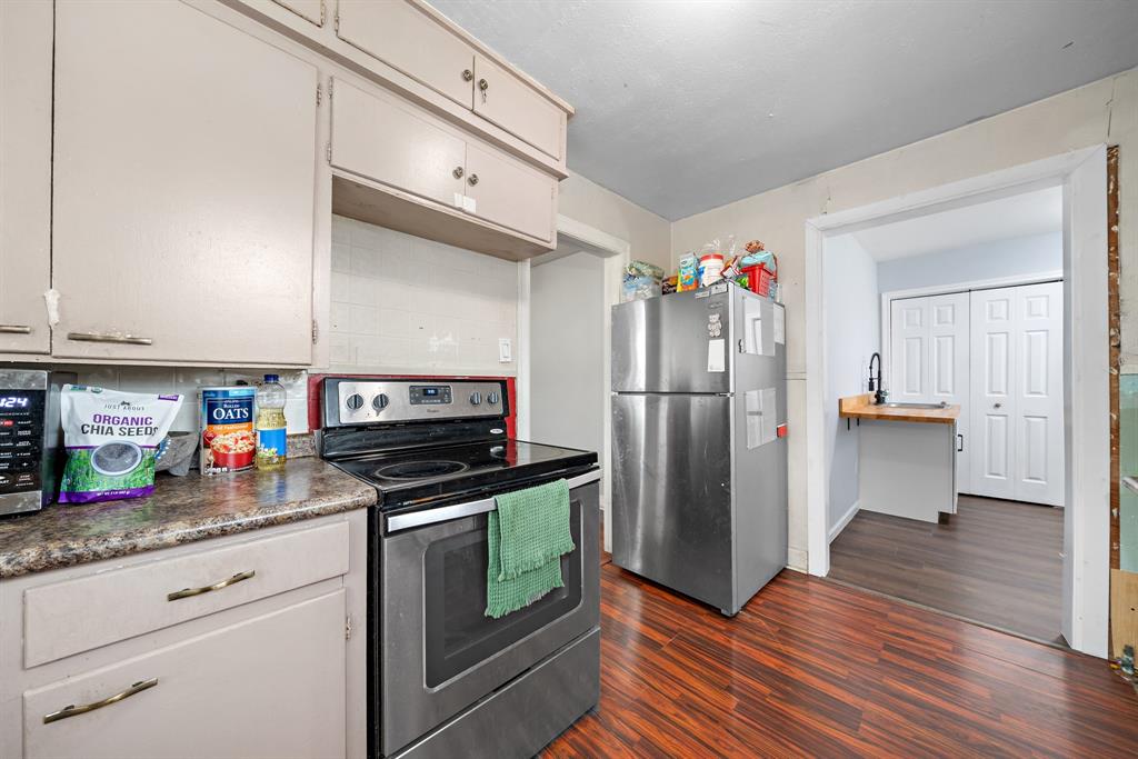 2119 Alexander Avenue Waco, TX 76708 - Photo 11 of 20 a kitchen with stainless steel appliances granite countertop a refrigerator and a stove top oven