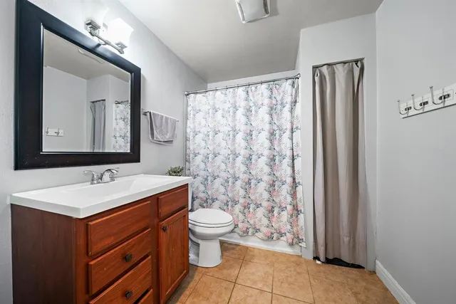 a bathroom with a sink toilet and mirror