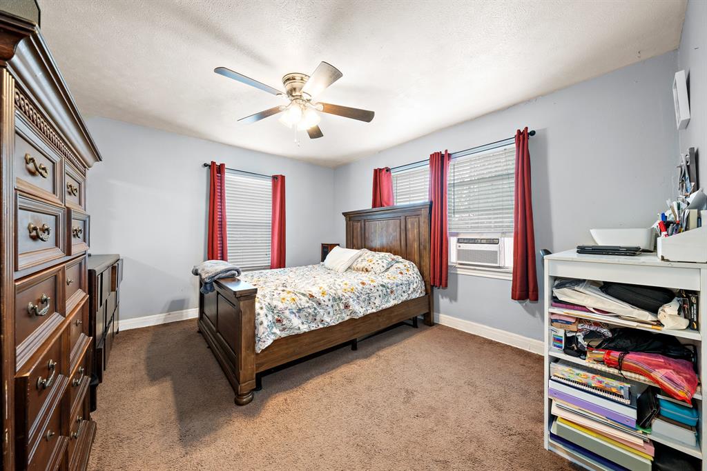 2119 Alexander Avenue Waco, TX 76708 - Photo 15 of 20 a bedroom with a bed bookshelf and a desk