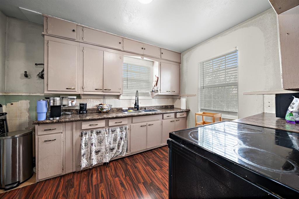 2119 Alexander Avenue Waco, TX 76708 - Photo 9 of 20 a kitchen with stainless steel appliances granite countertop a sink stove and cabinets