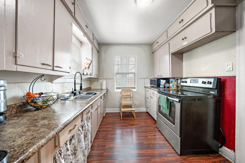 2119 Alexander Avenue Waco, TX 76708 - Photo 10 of 20 a kitchen with granite countertop lots of counter top space a sink and wooden floor