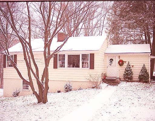 14 Ridgewood Road Wilton, CT 06897 - Photo 1 of 1 a front view of a house with a yard covered in snow