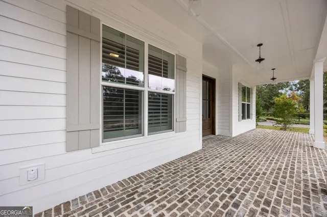 a kitchen with stainless steel appliances kitchen island granite countertop a table chairs and a refrigerator