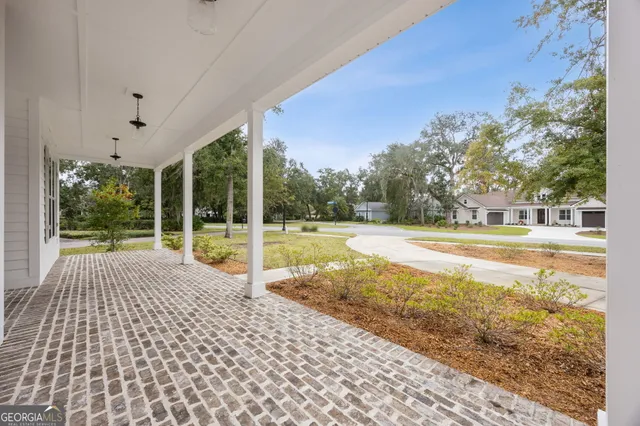a kitchen with granite countertop white cabinets and stainless steel appliances