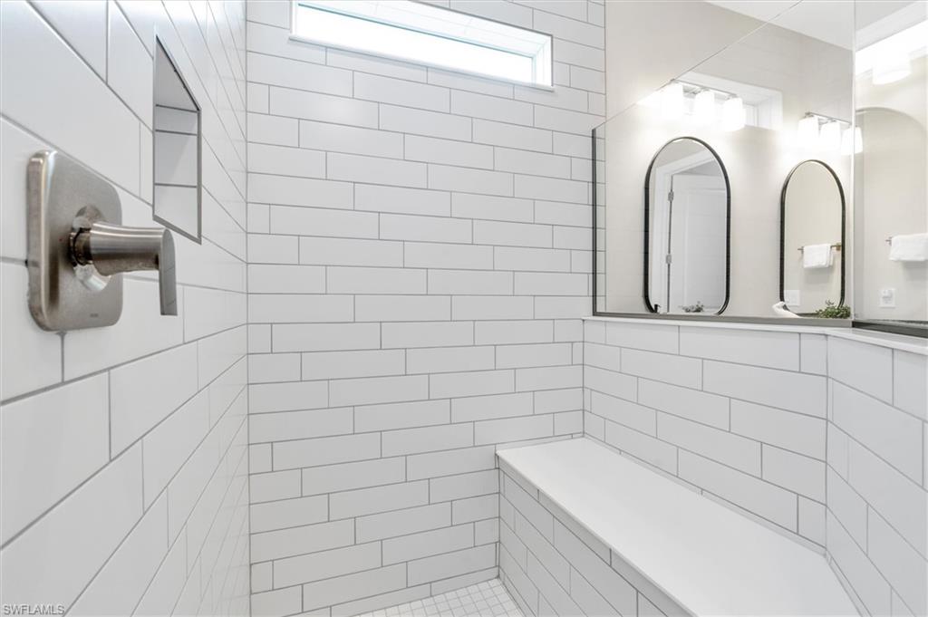 42322 Edgewater Drive Babcock Ranch, FL 33982 - Photo 18 of 40 a bathroom with a white bathtub and a window