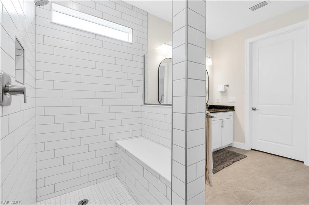 42322 Edgewater Drive Babcock Ranch, FL 33982 - Photo 19 of 40 a bathroom with a bathtub and shower