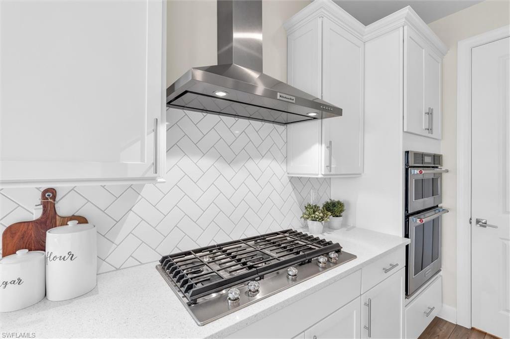 42322 Edgewater Drive Babcock Ranch, FL 33982 - Photo 8 of 40 a white stove top oven sitting inside of a kitchen