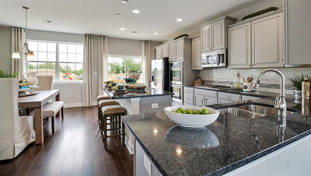 1705 Hights Farm Road South Raleigh, NC 27603 - Photo 13 of 25 a kitchen with a table chairs stove and cabinets