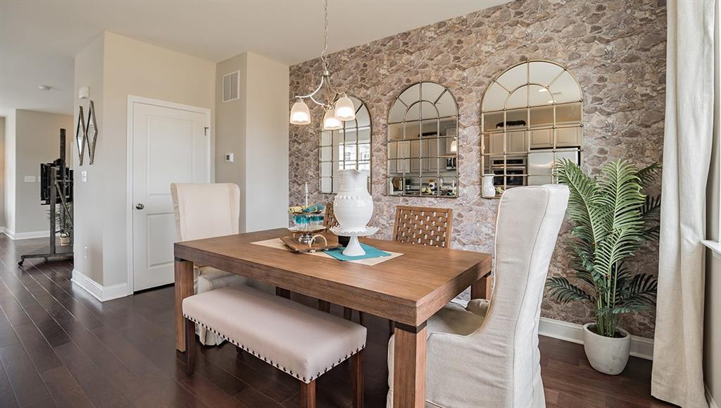 1705 Hights Farm Road South Raleigh, NC 27603 - Photo 16 of 25 a view of a dining room with furniture and wooden floor