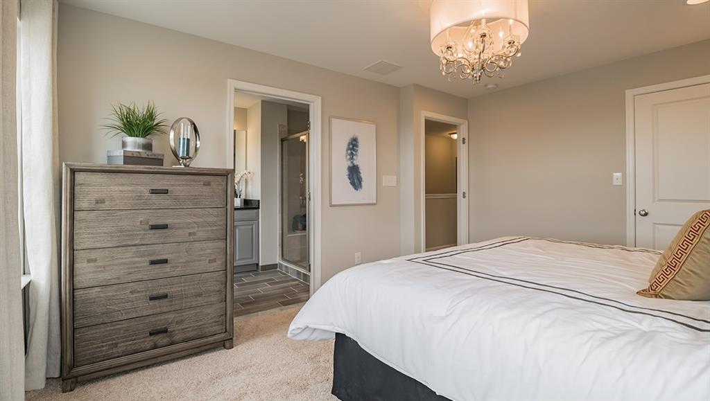 1705 Hights Farm Road South Raleigh, NC 27603 - Photo 4 of 25 a bedroom with a bed and a chandelier