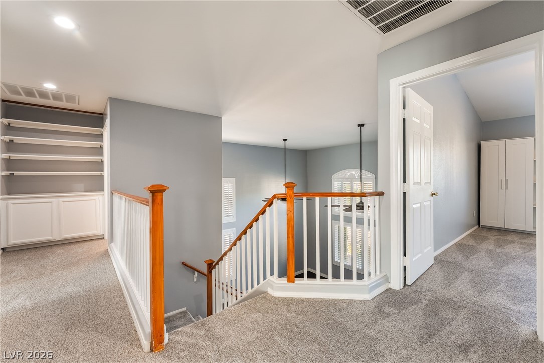 261 Timber Hollow Street Henderson, NV 89012 - Photo 27 of 51 An inviting stairway leads to an upper-level loft, offering built-in shelving and ample natural light.