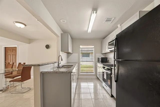 a kitchen with refrigerator and window