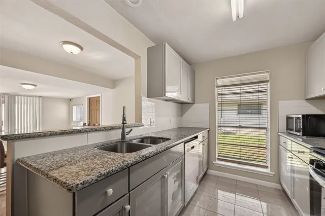 a kitchen with stainless steel appliances granite countertop a sink stove and cabinets