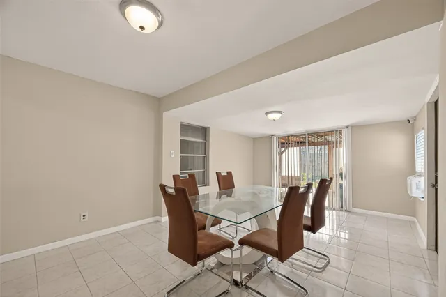 a view of a dining room with furniture and window