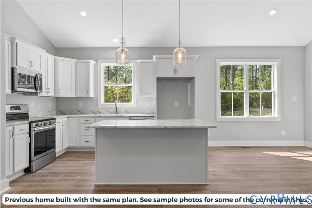 2638 West Creek Road Crewe, VA 23930 - Photo 4 of 29 a kitchen with stainless steel appliances granite countertop a stove a sink dishwasher a refrigerator and a microwave oven with wooden floor