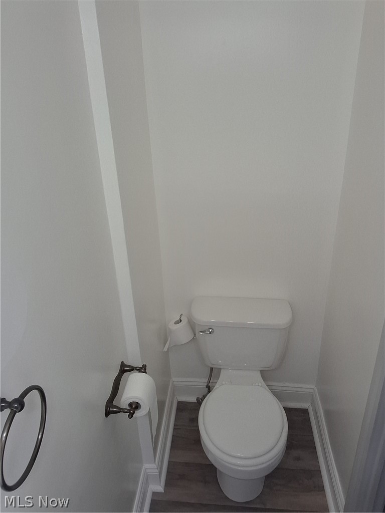 236 Bowland Road Mansfield, OH 44907 - Photo 21 of 34 White porcelain toilet with wood-finish flooring, white baseboards, and a bronze-finish toilet paper holder