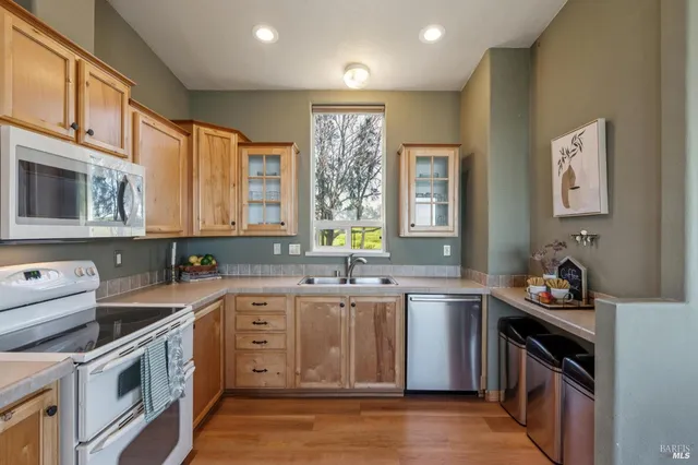 a kitchen with a sink stove and cabinets
