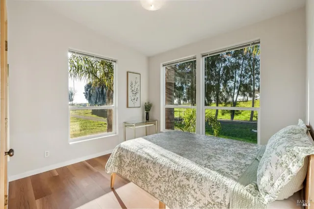 a bed sitting in a bedroom next to a window
